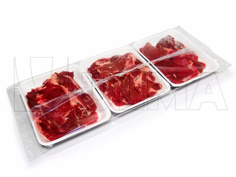 Secondary packaging in modified atmosphere (MAP) of group of meat fillets in trays wrapped in stretch film