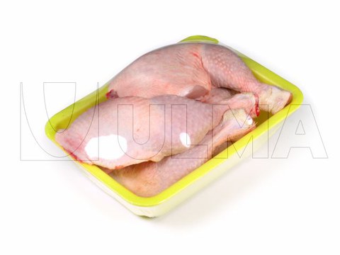 Chicken legs tray packaging in stretch film.